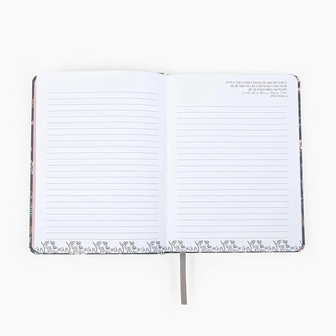 Open notebook with lined pages on a white background showing scripture inserts 